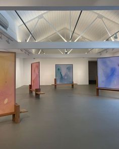 an empty room with paintings on the walls