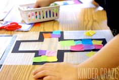 a child is making a cross out of construction paper