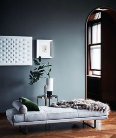 a living room with grey walls and wooden floors