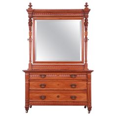 an antique dresser with mirror on top and drawers in the bottom drawer, against a white background