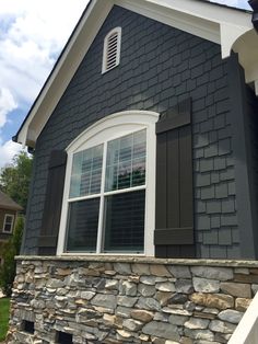 a black house with white trim and shutters