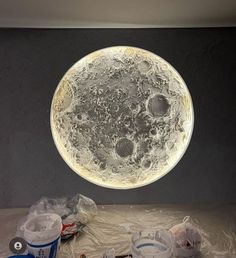 an image of a full moon in the sky above plastic wrapped around cans and containers