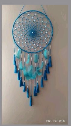 a blue dream catcher hanging on the wall