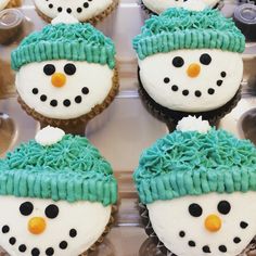 cupcakes decorated with frosting and snowmen on top of muffin tins