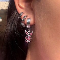 a close up of a person's ear wearing some kind of earrings with flowers on them