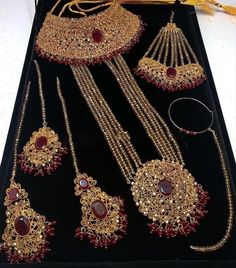 an assortment of jewelry is displayed on a table