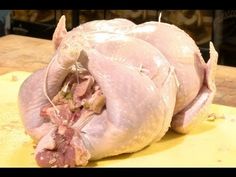 a raw chicken sitting on top of a cutting board