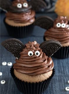 some cupcakes with chocolate frosting and googly eyes