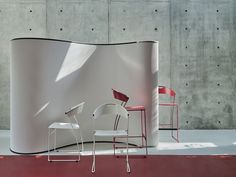 two chairs and a table in front of a wall