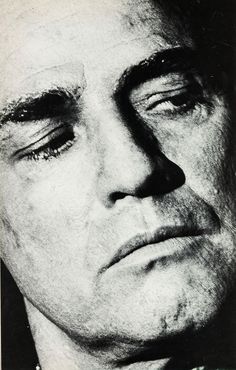 an old black and white photo of a man's face with his eyes closed