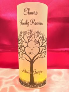 a wine bottle with a family tree on the front and bottom is sitting on a table