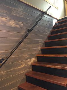 a set of wooden stairs leading up to a wall