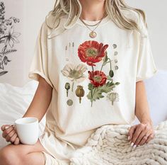 Botanical Shirt,Botanica Tee, Wildflower Shirt, Garden Shirt, Plant Lover Gift,Wildflower Tee,Plant Shirt,Boho Wildflowers,Cottagecore Shirt ⭐Please Check All Photos For Details.   🐞Choose Your T-Shirt Size From The Drop-Down Lists Next To The item Picture   ⭐Choose Of Your T-Shirt Color From The 2nd Picture   🐞Use "Add message to Seller" link On The Checkout Page To Send me the Following important Details For Your Order's Customization.   ⭐Shipping Time Varies by location (we are located in S Cottagecore Tops With Plants Print And Relaxed Fit, Cottagecore Floral Print Summer Shirt, Cottagecore Tops With Plant Print And Relaxed Fit, Cottagecore Relaxed Fit Tops With Plant Print, Cottagecore Floral Print Short Sleeve Shirt, Relaxed Fit Cottagecore Tops With Plant Print, Bohemian Spring Shirt With Plants Print, Cotton Cottagecore Shirt With Floral Print, Bohemian Shirt With Plants Print For Spring