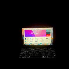 a laptop computer sitting on top of a black table next to a keyboard and mouse