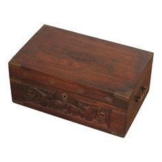 an old wooden box with carvings on the lid and sides, isolated against a white background