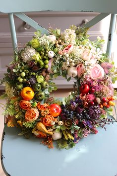 a floral wreath sitting on top of a blue chair