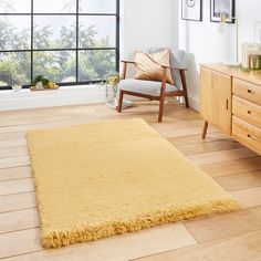 a living room with wooden floors and large windows