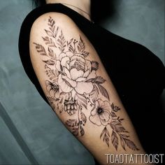 a woman with a flower tattoo on her arm