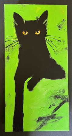 a painting of a black cat with yellow eyes on a green background, is shown