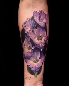 a purple flower tattoo on the leg