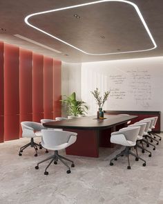 a conference room with chairs and a large table in the center, along with a chalkboard on the wall