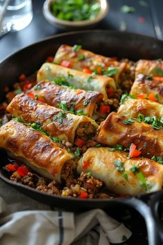 Stuffed pasta rolls with minced meat and vegetables, garnished with chopped herbs in a black skillet. Skillet Egg Roll Recipe, Egg Skillet, Skillet Dishes, Egg Roll Recipes, Wontons, Culinary Experience, Coleslaw Mix, Roll Recipe