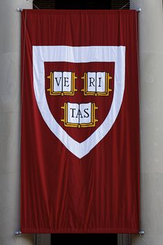 a red and white banner hanging from the side of a building