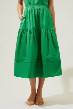 The perfect closet staple has arrived. A classic, cotton midi skirt that features an elastic waist for comfort tops an A line silhouette. Tiers break the skirt up, along with pleats that wrap around the lower tier. Pair it with a ribbed tank or an eyelet cami for the ultimate summer look.- Breathable- Pockets- A line- Pleats- Comes in 4 colorsSize + Fit - Model is 5'9" and wearing size S- Measurements taken from size S - Waist: 12 1/2"- Length: 32 1/4" Fabric self: 100%cotton Style Number STS702 Wrap Midi Skirt, Cotton Midi Skirt, Perfect Closet, Comfortable Tops, Ribbed Tank, Pleated Midi Skirt, Summer Look, Kelly Green, Petticoat