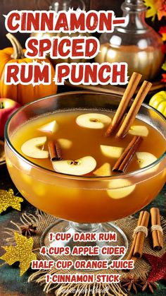 cinnamon - spiced rum punch recipe in a glass bowl with apples and cinnamon sticks