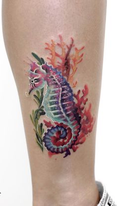 a colorful seahorse tattoo on the leg