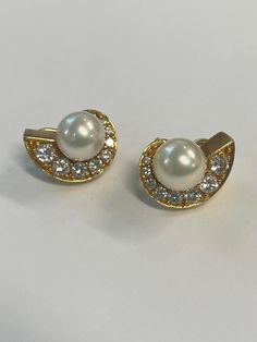 18K yellow gold swirl earrings with a 9 mm cultured pearl center and diamonds by master goldsmith Sean Gilson. The diamonds ( 16 stones total) weigh approximately 1.25 carat total. ( Beautiful very good quality stones with a lot of sparkle ) The earrings measure 1/2 inch wide and 3/4 inch tall. Both earrings are hallmarked ( but only one is legible)  18K S Gilson Please note: look at the second picture to see how they sit on the earlobe. Gold Brilliant Cut Pearl Earrings For Anniversary, Elegant Gold Pearl Earrings Brilliant Cut, Elegant Gold Pearl Earrings With Brilliant Cut, Swirl Earrings, Pearl And Diamond Earrings, Diamond Earring, Earring Studs, Gold Pearl, Diamond Earrings Studs