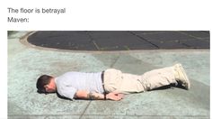 a man is laying on the ground with his head down and arms out to side