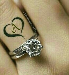 a woman's hand with a ring on it and a diamond in the middle