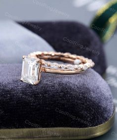 an engagement ring on top of a velvet cushion