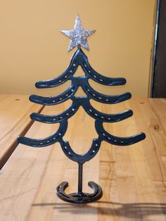 a small wooden christmas tree sitting on top of a table