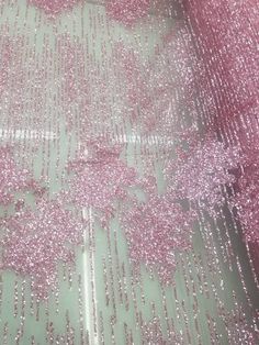 pink sequins are on the ground in front of a green wall and floor