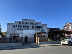 a car parked in front of a building with a sign that reads humboldt machine works