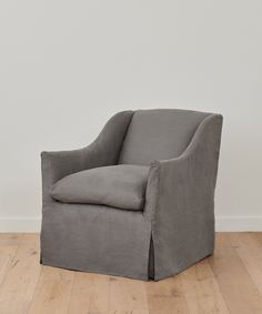 a grey chair sitting on top of a hard wood floor