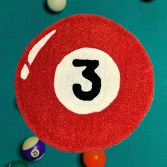 a pool table with balls on it and the number three