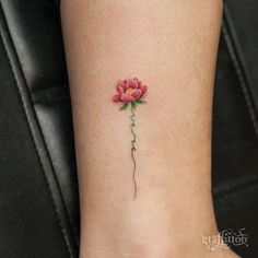 a small rose tattoo on the ankle