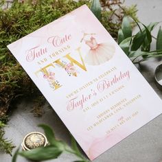 a pink and gold ballerina birthday party with flowers, greenery and rings on the ground