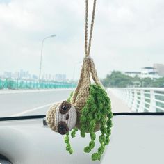 a car dashboard with a stuffed animal hanging from it's side