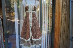 "Brown floral size  5 (fits more like 3) prairie dress. NOT A GUNNE, made by homespun - very rare dress. Condition - has some light fading in color- see last two photos. Measurements taken across front laid flat  16\" across front armpit to armpit 12.5\" across front of waist  45\" length" Cottagecore Prairie Dress With Ruffles And Square Neck, Fitted Vintage Brown Prairie Dress, Fitted Brown Vintage Prairie Dress, Fitted Cotton Prairie Dress, Cottagecore Vintage Dress With Ruffles And Square Neck, Pastoral Prairie Dress With Ruffles For Garden Party, Prairie Dress With Ruffles For Daywear, Daywear Prairie Dress With Ruffles, Cotton Prairie Dress With Ruffles For Garden Party