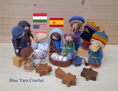 several crocheted nativity figurines with flags in the background