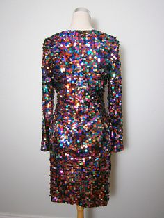 "This is a BOLD and FUN little dress from Oleg Cassini Black Tie. It's fully embellished with multicolored paillette sequins and is in perfect condition! Note, there's some stretch in the material. Bust - 36-40\" Waist - 28-32\" Hips - 38-42\" Length - 37\" Tag Size - 10 This dress comes from a pet-free and smoke-free home. If you would like more info or have any questions, please don't hesitate to ask!"