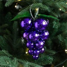 a purple ornament hanging from a christmas tree