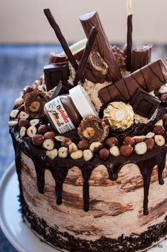 a cake with chocolate, nuts and marshmallows on it