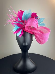 A bright pink button base with a stunning pink jinsin bow with pink and aqua blue feathers.  Sits on a comfortable black headband. Ships in a high quality storage box. One of a kind.  Perfect for Kentucky Derby, Royal Ascot, church, weddings, just for fun. Pink Fascinator For Royal Ascot Gift, Pink Feather Fascinator For Royal Ascot, Pink Feathered Fascinator For Races, Pink Curved Brim Fascinator For Event, Pink Summer Fascinator With Feathers, Adjustable Pink Fascinator With Feathers, Pink Adjustable Fascinator With Feathers, Luxury Pink Fascinator, Adjustable Pink Feather Fascinator