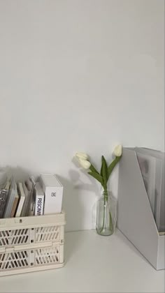 there is a vase with flowers in it on the shelf