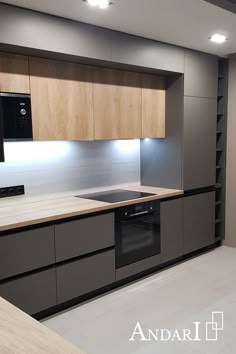 an empty kitchen with wooden cabinets and black appliances